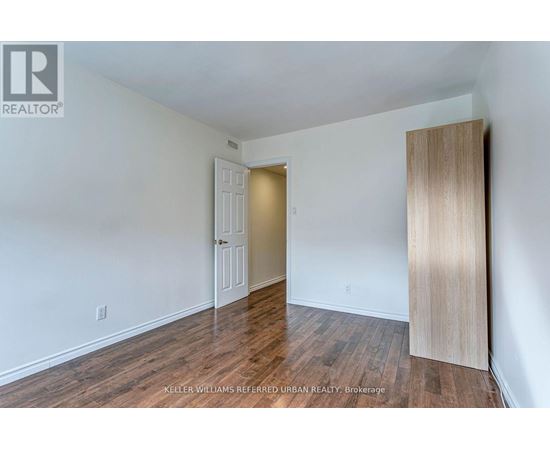 A room with a white door and a wooden door frame.