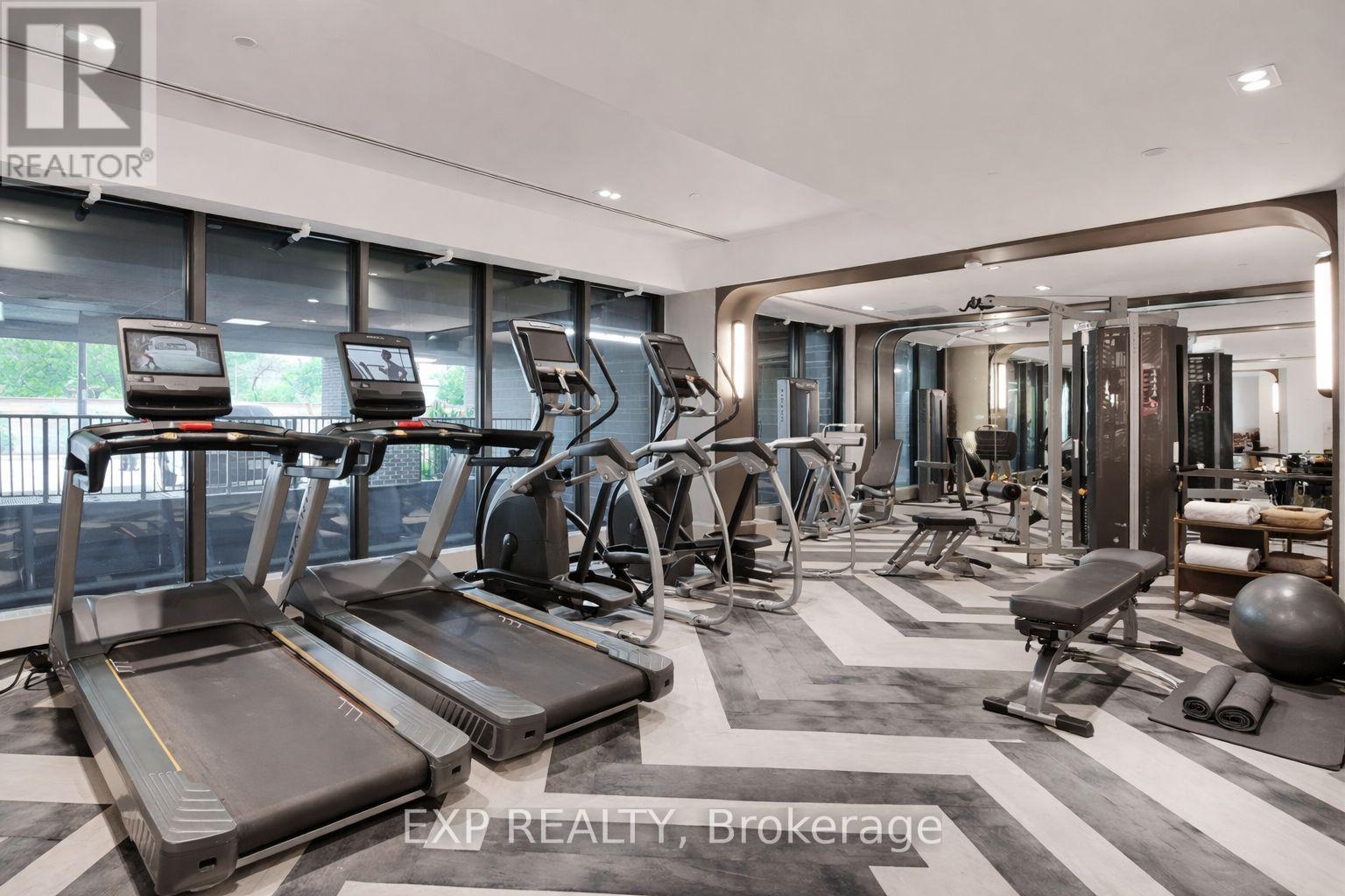 A gym with treadmills, exercise bikes, and weights.