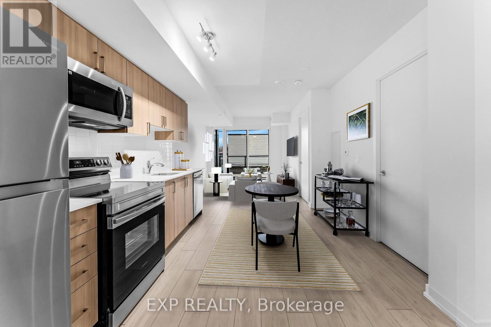 A modern kitchen with a dining table set up in the middle.