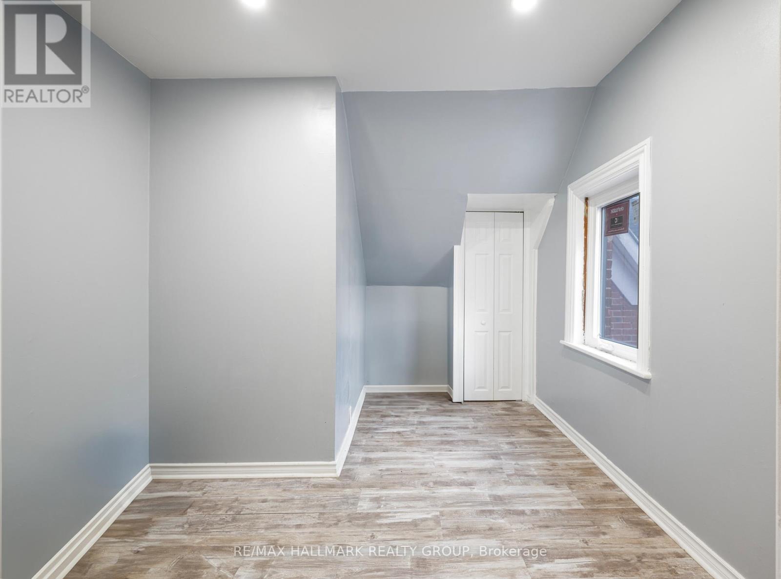A room with a wooden floor and white walls.