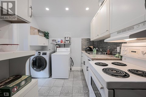 A white kitchen with a stove top oven and a dishwasher.