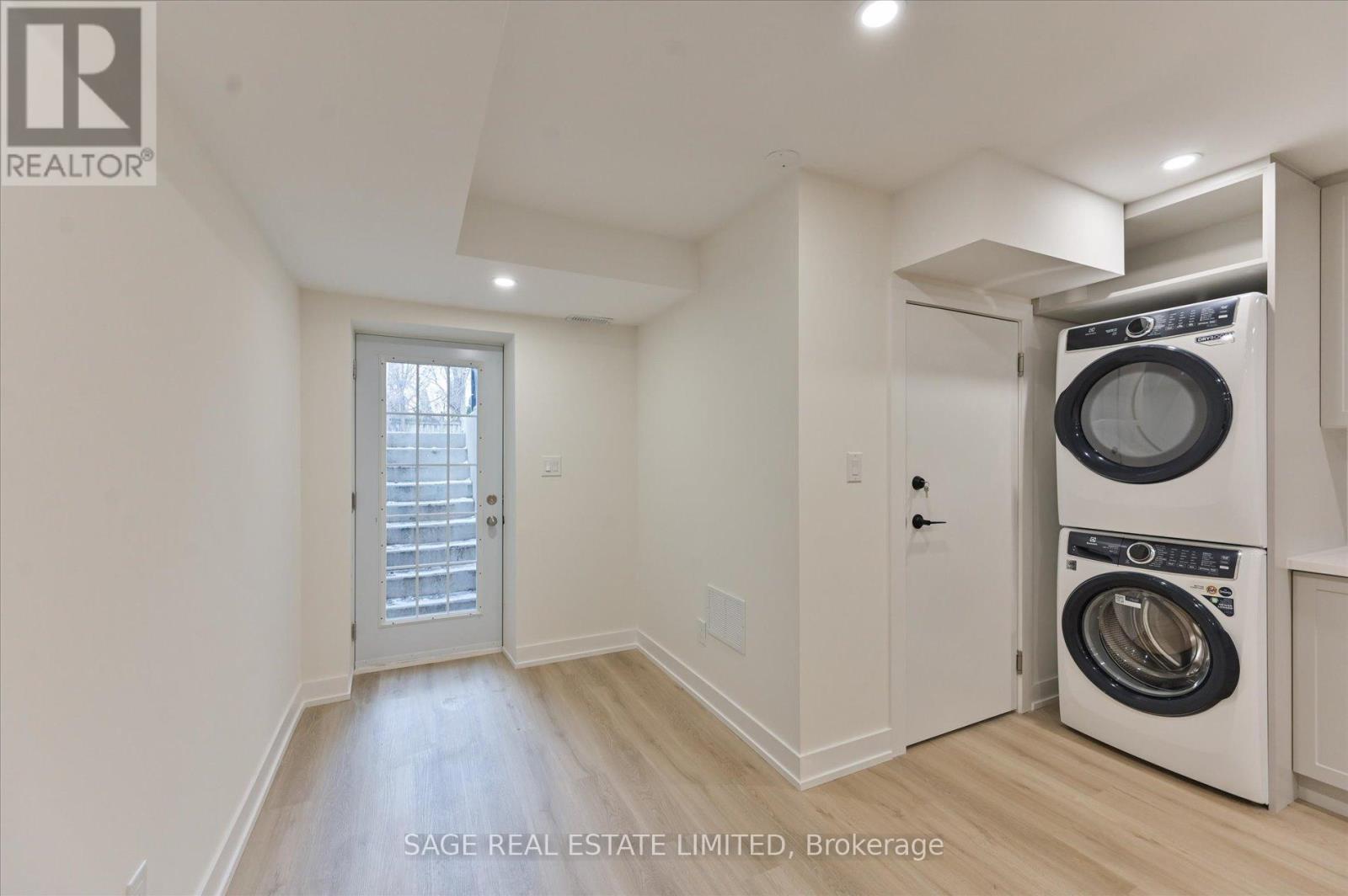 A laundry room with a washer and dryer built into the cabinetry.