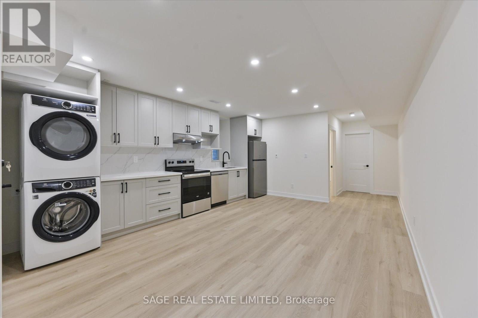 A modern kitchen with a washing machine built into the cabinetry.