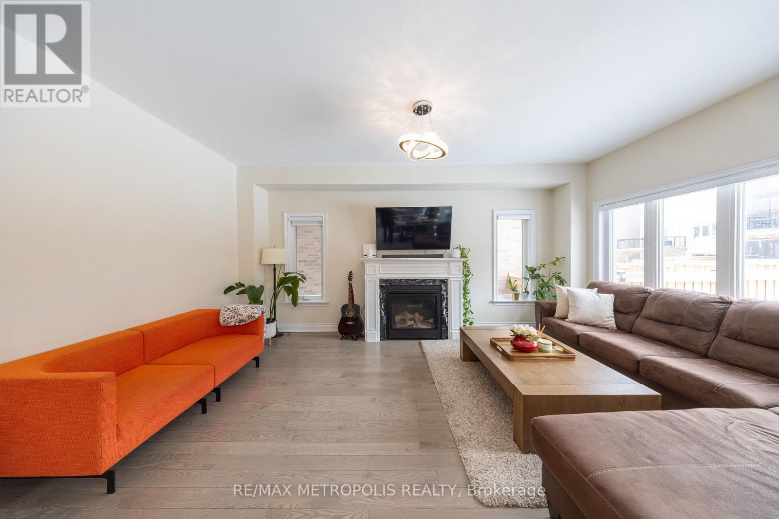 A living room with a fireplace and a television.