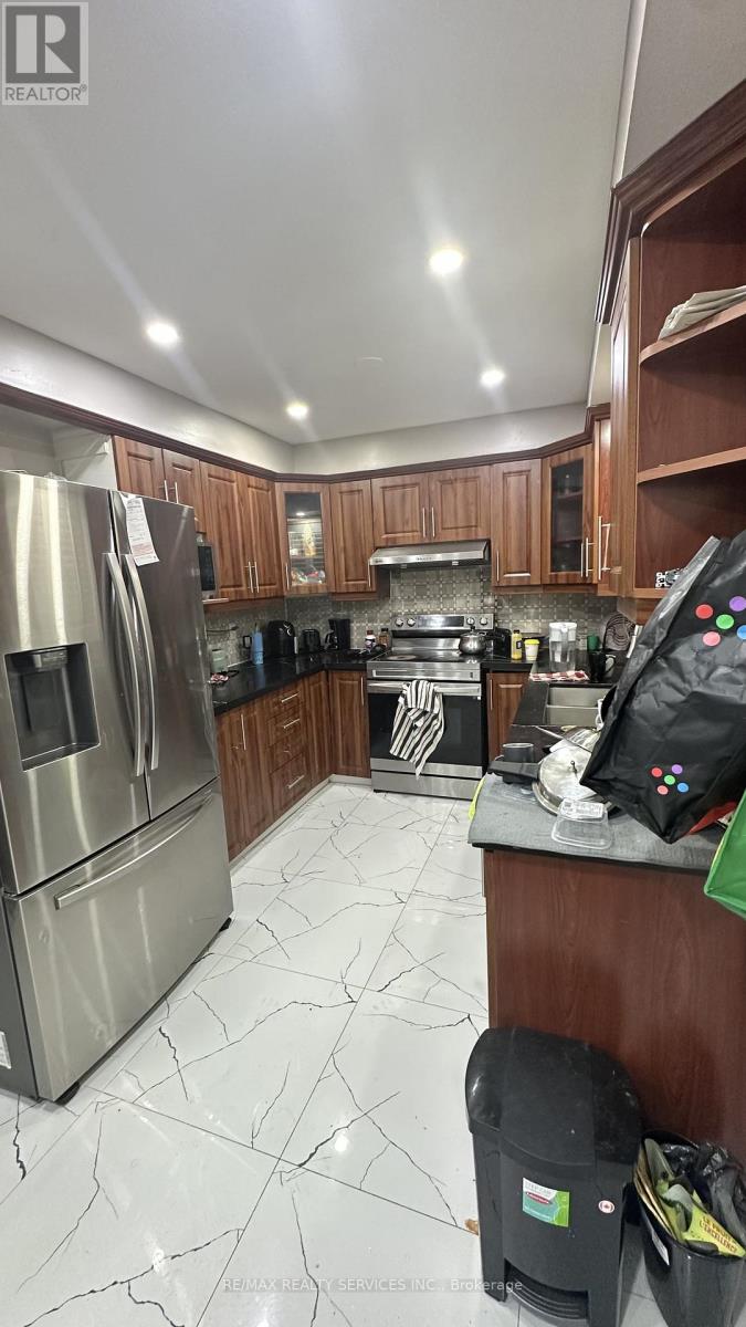 A kitchen with a refrigerator, stove, and oven.