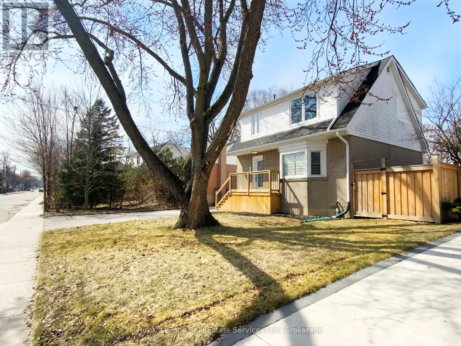 A house with a tree in front of it.