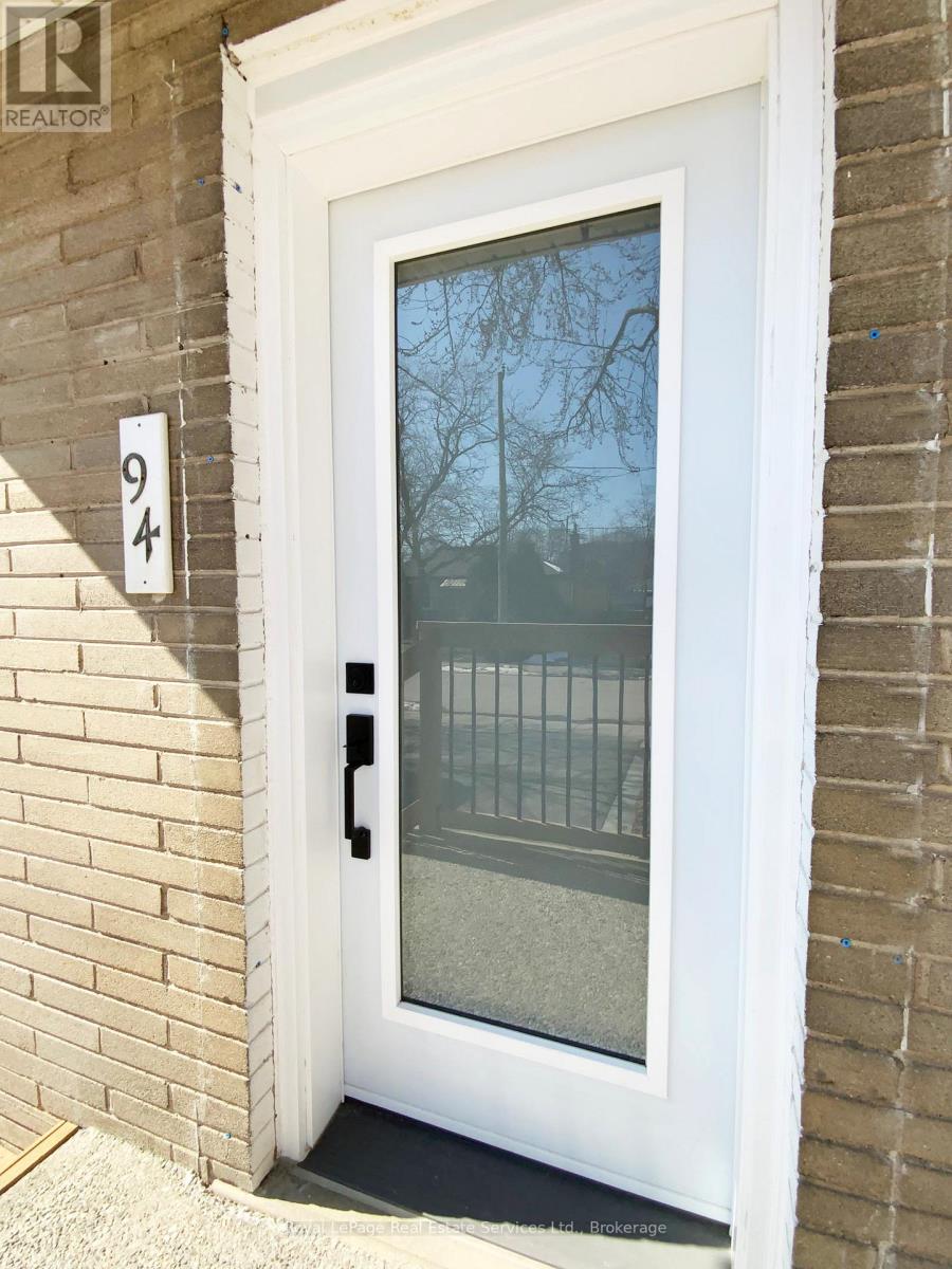 A white door with a glass window and a black handle.