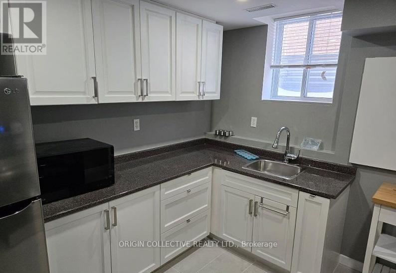 A kitchen with Origin Collective Realty Ltd. Brokerage watermark.