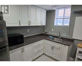 A kitchen with Origin Collective Realty Ltd. Brokerage watermark.