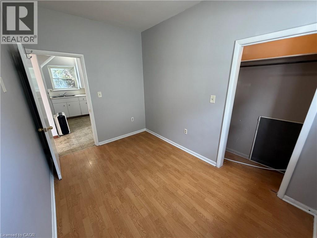 A room with wooden flooring and a fireplace.