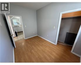 A room with wooden flooring and a fireplace.