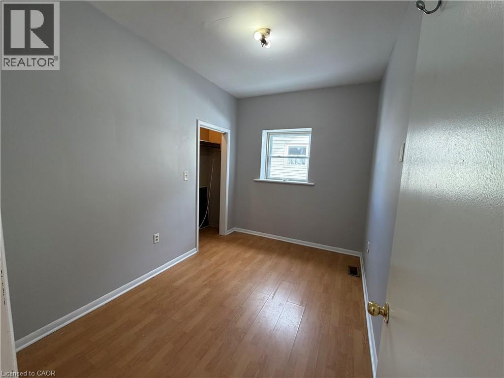 A room with wooden flooring and a window.