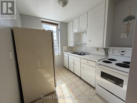 A kitchen with white cabinets and appliances.