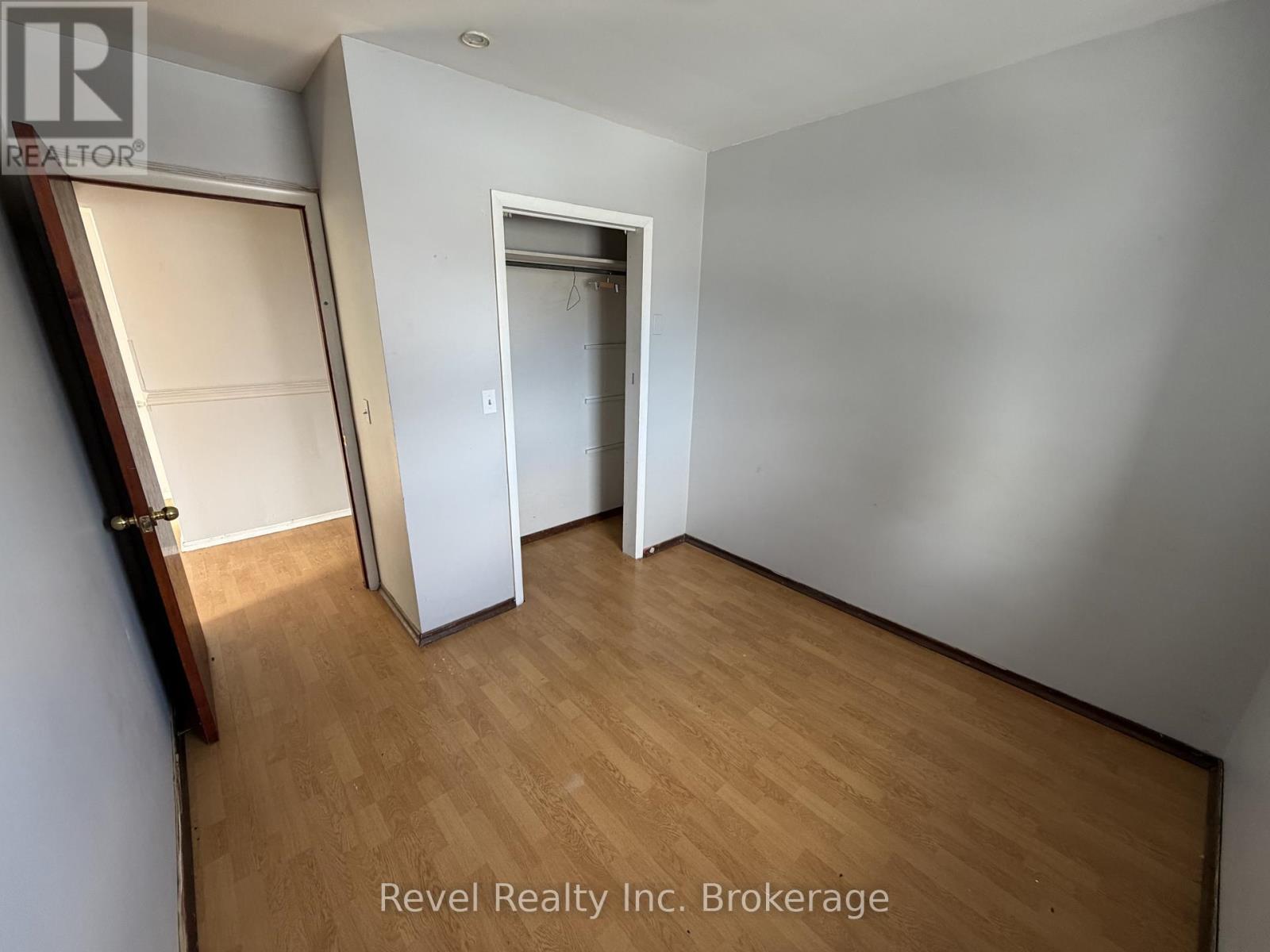 A room with a wooden floor and a white door.