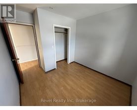 A room with a wooden floor and a white door.