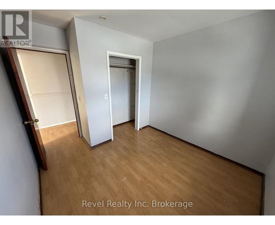 A room with a wooden floor and a white door.