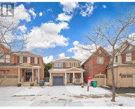A row of houses with a blue sky and clouds above them.