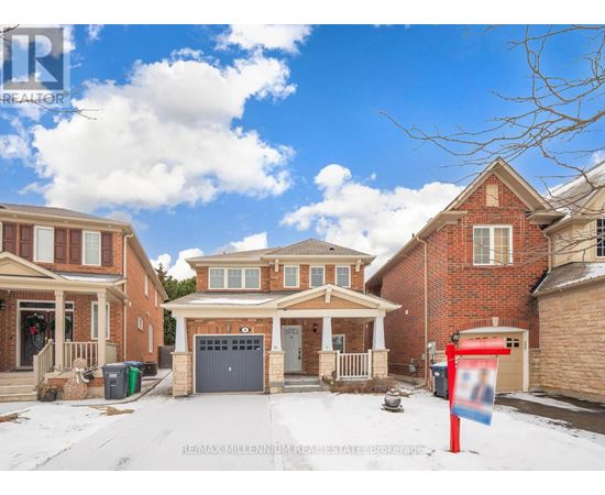 A real estate sign is in front of a house with a garage.