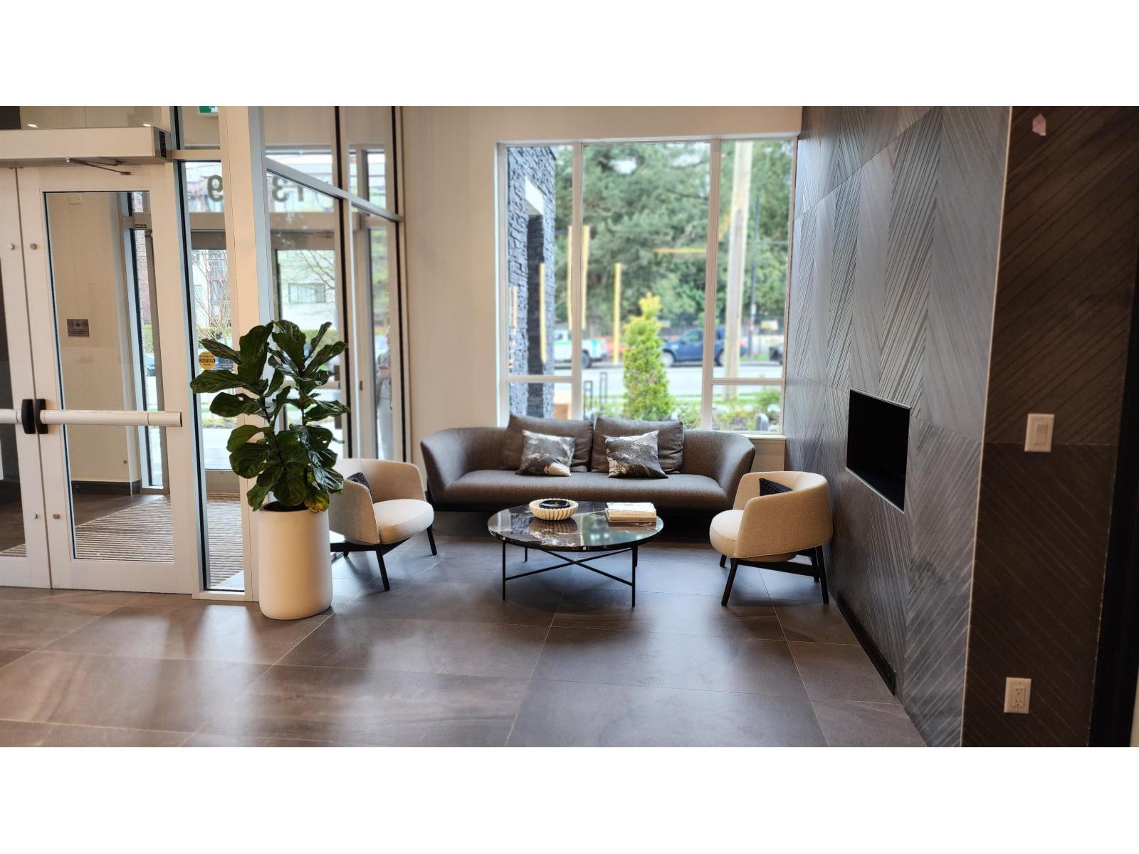 A living room with a couch, chairs, and a coffee table.