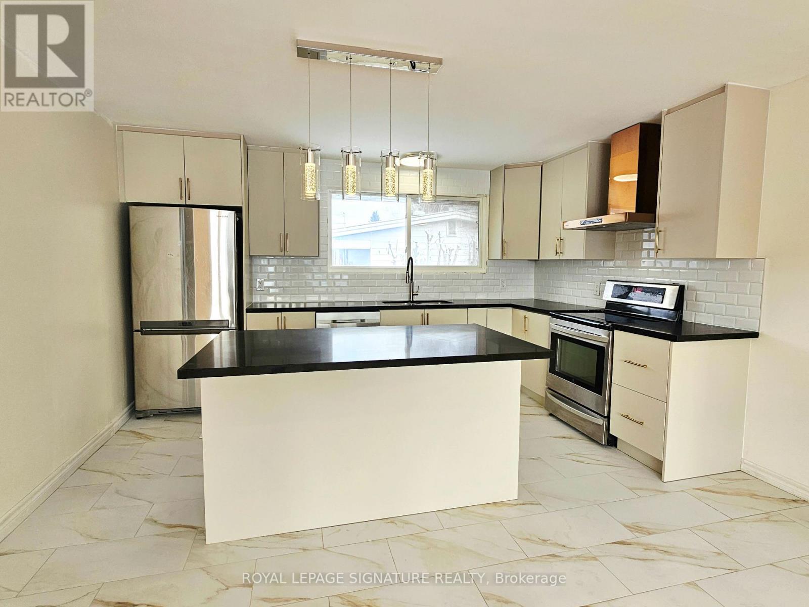 A kitchen with a black countertop and white cabinets.