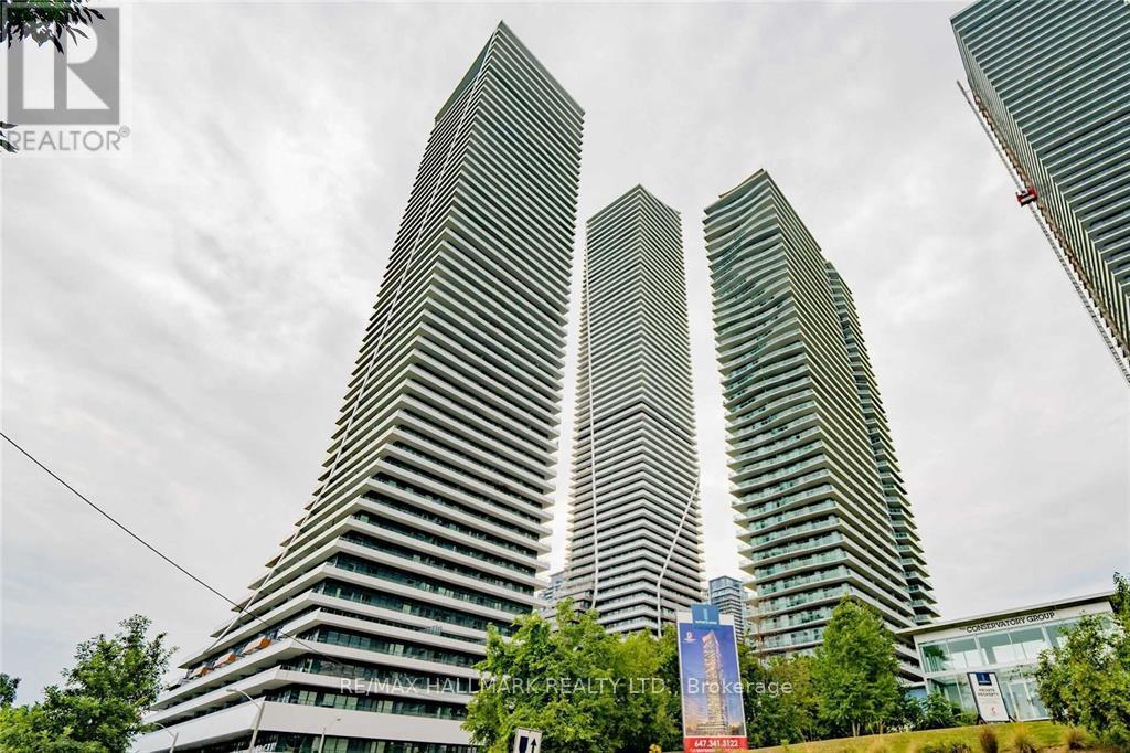 Three tall buildings with a blue sign in front of them.