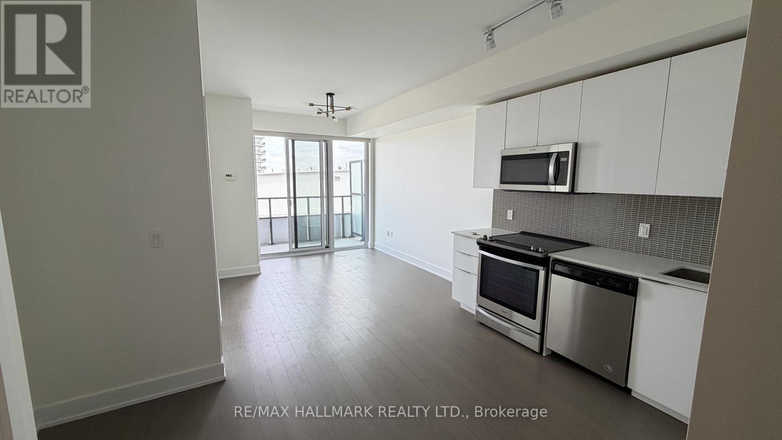 A kitchen with white cabinets and stainless steel appliances.