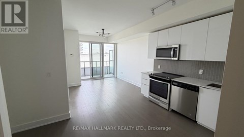 A kitchen with white cabinets and stainless steel appliances.