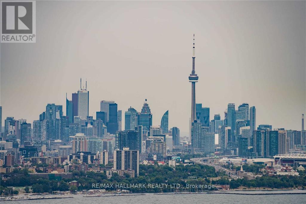A cityscape with the CN Tower in the background.
