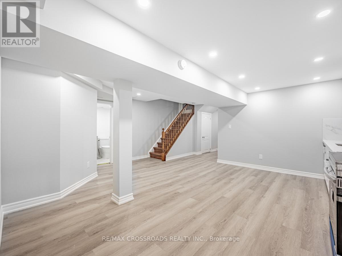 A spacious room with a staircase and white walls.