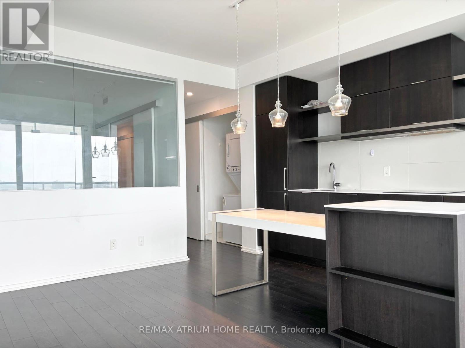 A modern kitchen with a long island in the middle.