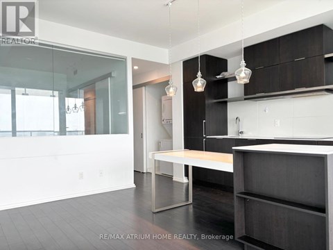 A modern kitchen with a long island in the middle.