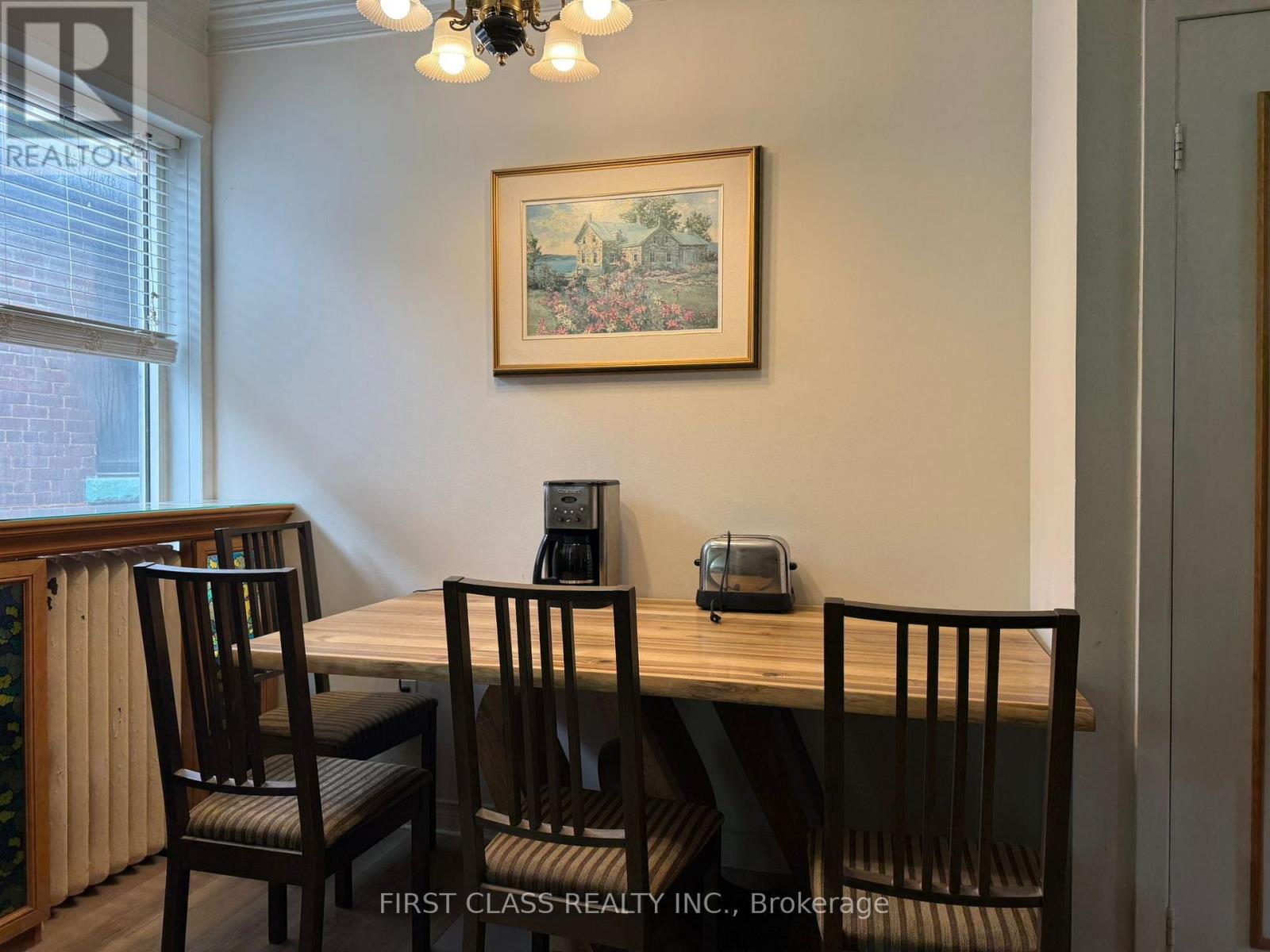 A dining room with a wooden table and chairs.