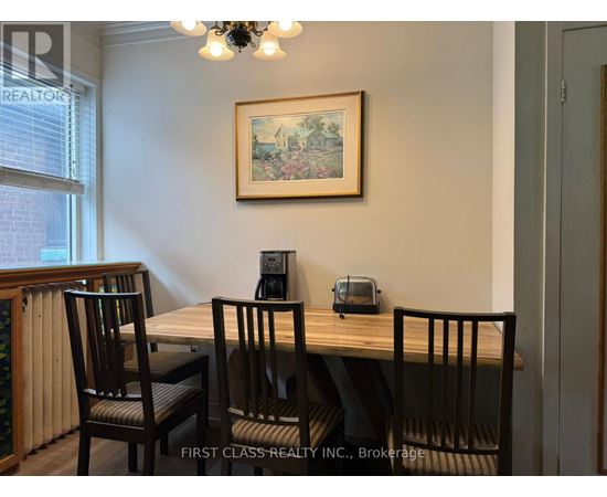 A dining room with a wooden table and chairs.