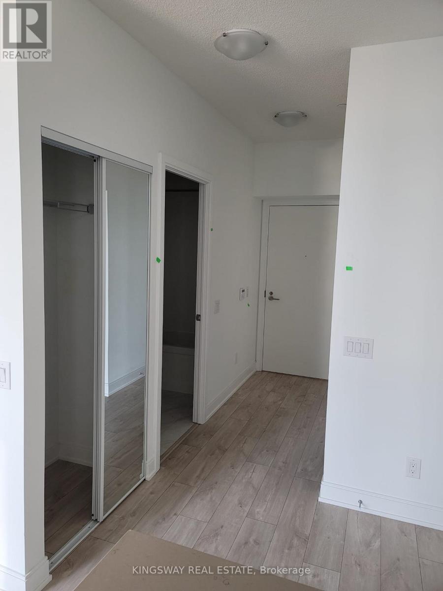 A white room with a door and a window.