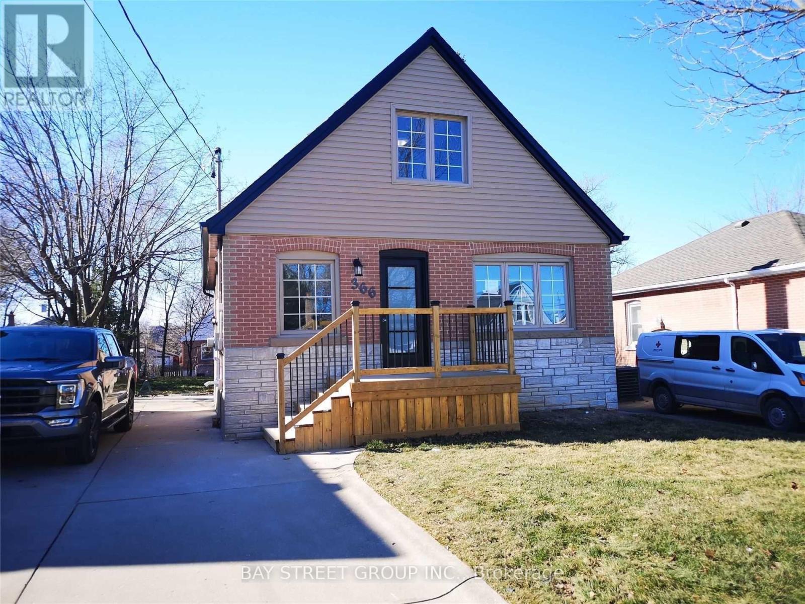 A small house with a porch and a truck parked in front.