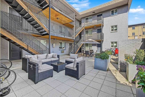A patio area with furniture and a bicycle.