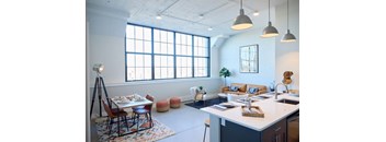 A kitchen and dining area with a table set for two.
