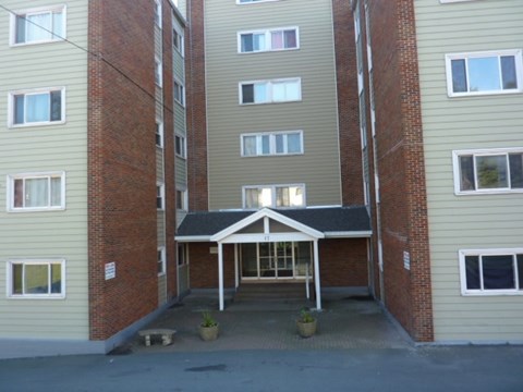 A building with a covered walkway between two sections.