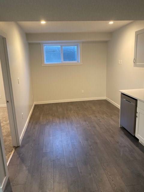 A room with a window and a dishwasher.