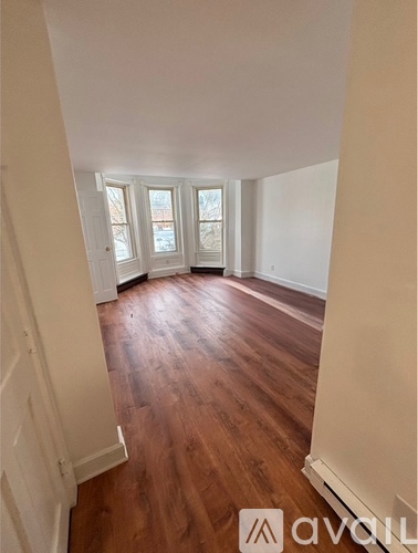 A room with wooden floors and white walls.