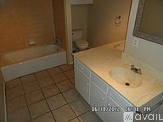 A bathroom with a sink, toilet and bathtub.