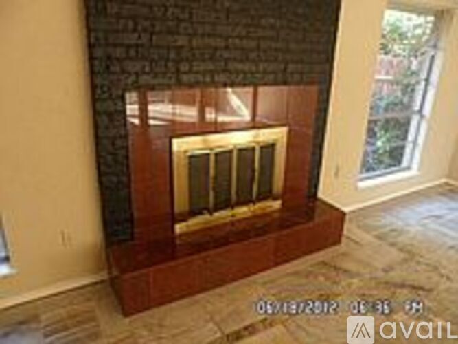A fireplace with a brick wall and a glass door.