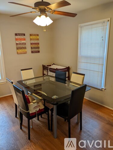 A dining room with a glass table and chairs.