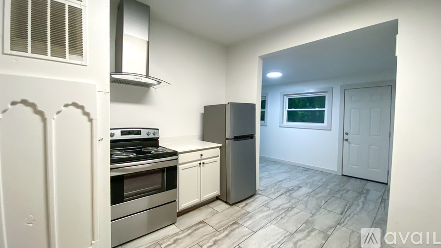 A kitchen with a stove, oven, and refrigerator.
