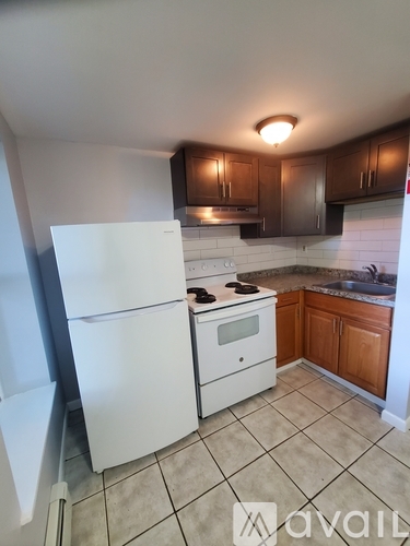 A kitchen with a white fridge and a white stove top oven.