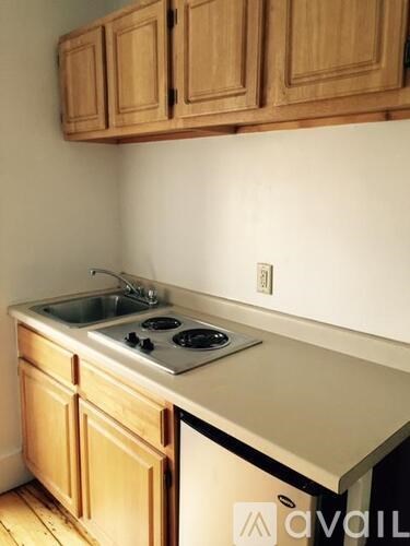 A kitchen with wooden cabinets and a white countertop.