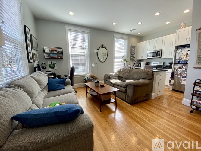 A living room with a grey couch and a wooden coffee table.