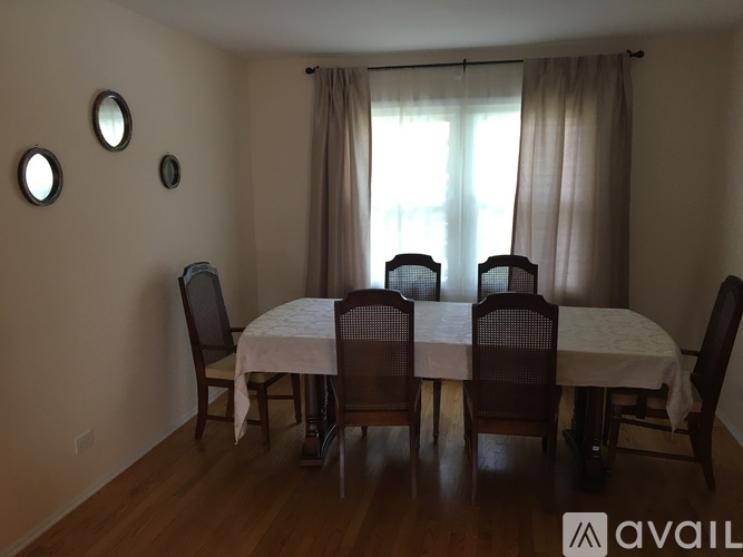 A dining room with a table set for four.