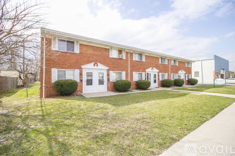 A row of houses with a grassy front yard.