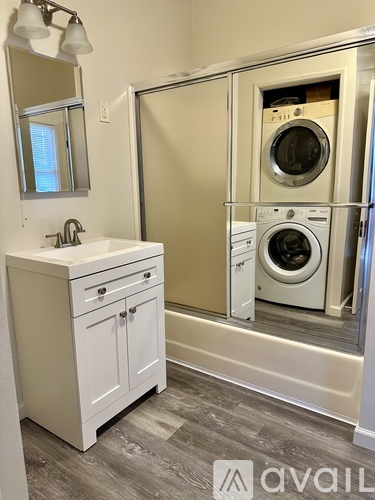 A small laundry room with a washer and dryer.